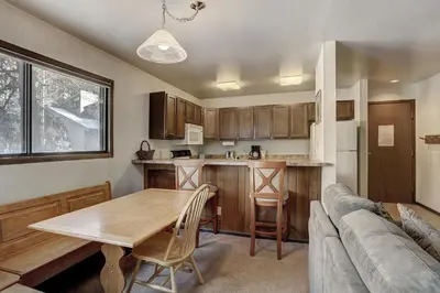 a kitchen with a table and a couch at 1125 Flying Dutchman Condo in Keystone