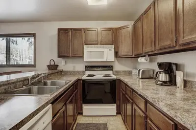 a kitchen with a sink and a stove top oven at 1125 Flying Dutchman Condo in Keystone