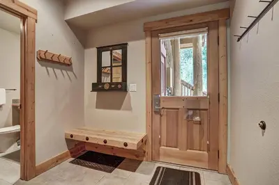 a bathroom with a wooden door and a window at 8757 Trappers Crossing Condo in Keystone