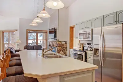 a kitchen with a sink and a refrigerator at 5983 Hidden River Lodge Condo in Keystone