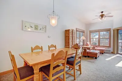 a dining room with a wooden table and chairs at 5983 Hidden River Lodge Condo in Keystone