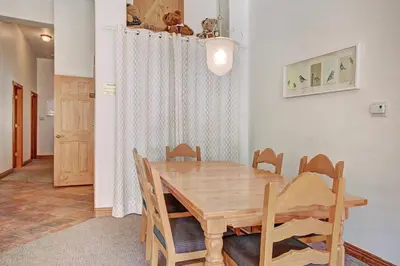 a dining room with a wooden table and chairs at 5983 Hidden River Lodge Condo in Keystone