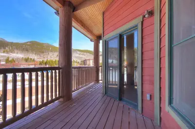 a wooden deck with glass doors on a house at 5983 Hidden River Lodge Condo in Keystone