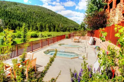 a patio with a swimming pool and a fence at 5983 Hidden River Lodge Condo in Keystone