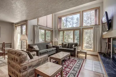 a living room with a couch and a fireplace at 1633 Quicksilver Condo in Keystone