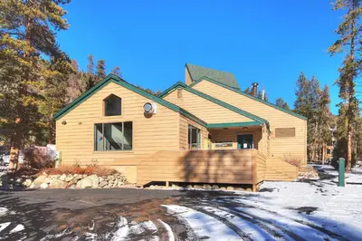 a wooden house with a porch in the snow at 1633 Quicksilver Condo in Keystone