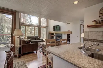a kitchen and living room with a sink and a couch at 1633 Quicksilver Condo in Keystone