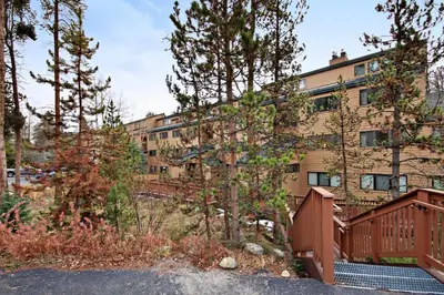 a building with a wooden fence in front of a building at 1633 Quicksilver Condo in Keystone