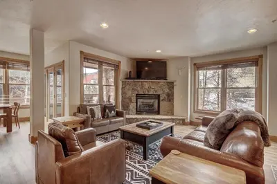 a living room with leather furniture and a fireplace at 201 Mill Creek Condo in Keystone