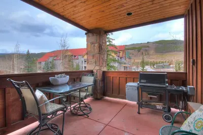 a screened in porch with a table and a stove at 201 Mill Creek Condo in Keystone