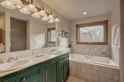 a bathroom with two sinks and a tub and a mirror at 201 Mill Creek Condo in Keystone
