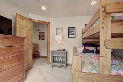 a bedroom with a bunk bed with a ladder at 201 Mill Creek Condo in Keystone