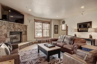 a living room with a couch and a fireplace at 201 Mill Creek Condo in Keystone