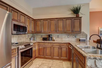 a kitchen with wooden cabinets and a sink at 8912 The Springs Condo in Keystone