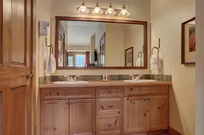 a bathroom with two sinks and a large mirror at 8912 The Springs Condo in Keystone