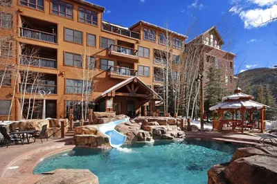 a resort with a slide in the middle of a pool at 8912 The Springs Condo in Keystone