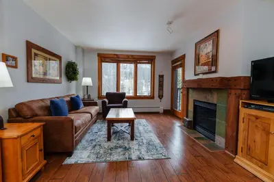 a living room with a couch and a fireplace at 8858 The Springs Condo in Keystone