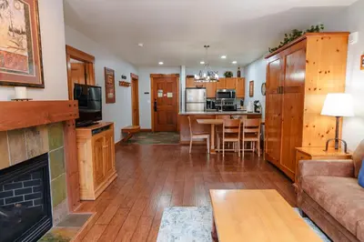 a living room with a couch and a fireplace at 8858 The Springs Condo in Keystone