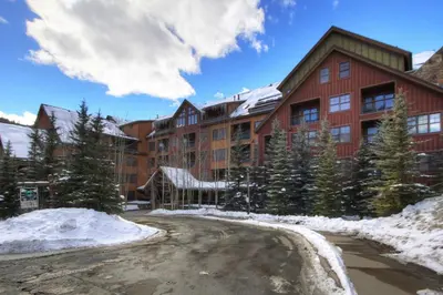 a large building with snow in front of it at 8858 The Springs Condo in Keystone