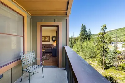 a balcony with a chair on a house at 8858 The Springs Condo in Keystone