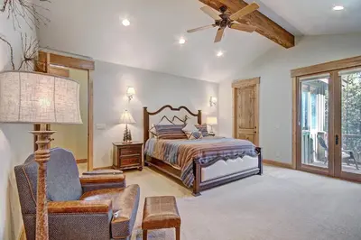 a bedroom with a bed and a ceiling fan at 170 Elk Circle Condo in Keystone
