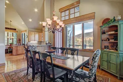 a kitchen and dining room with a table and chairs at 170 Elk Circle Condo in Keystone