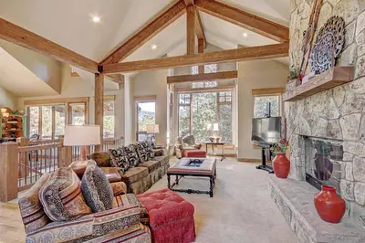 a large living room with a stone fireplace at 170 Elk Circle Condo in Keystone