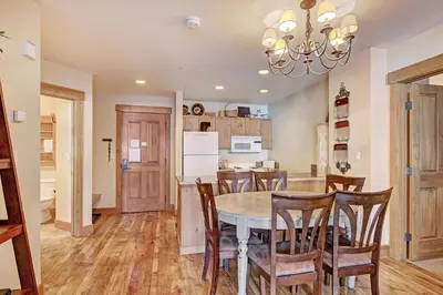 a kitchen and dining room with a table and chairs at 8824 The Springs Condo in Keystone
