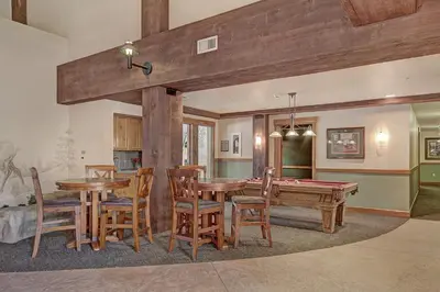 a dining room with a ping pong table and chairs at 8824 The Springs Condo in Keystone
