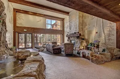 a living room filled with furniture and a large window at 8824 The Springs Condo in Keystone