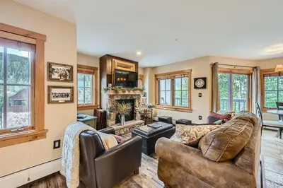 a living room with a couch and a fireplace at 8594 Expedition Station Condo in Keystone
