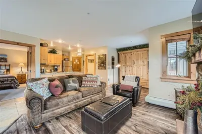 a living room with a couch and a chair at 8594 Expedition Station Condo in Keystone