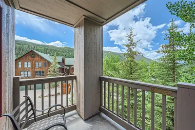 a balcony with a view of a house at 8594 Expedition Station Condo in Keystone