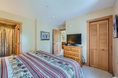 a bedroom with a bed and a flat screen tv at 8594 Expedition Station Condo in Keystone