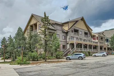 a large building with cars parked in front of it at 8594 Expedition Station Condo in Keystone