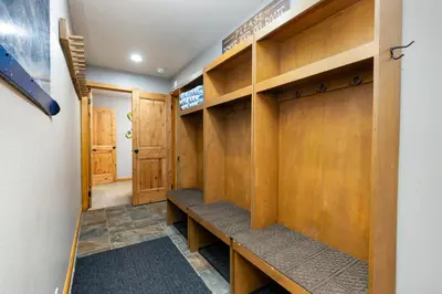 a locker room with wooden cabinets and benches at 2054 The Pines Condo in Keystone