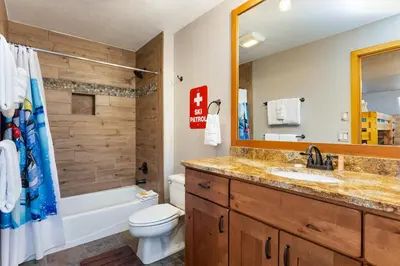 a bathroom with a sink and a toilet and a mirror at 2054 The Pines Condo in Keystone