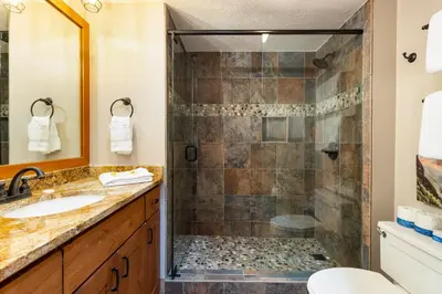 a bathroom with a shower and a sink at 2054 The Pines Condo in Keystone