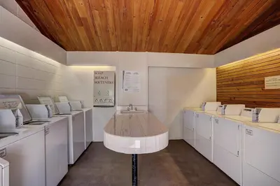 a room with white washing machines and a wooden ceiling at 2054 The Pines Condo in Keystone