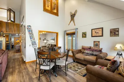 a living room with a table and a couch at 2054 The Pines Condo in Keystone