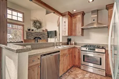 a kitchen with a sink and a stove top oven at 18 Autumn Brook Condo in Keystone