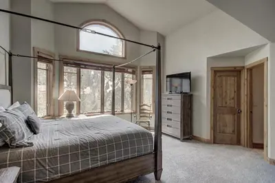 a bedroom with a bed and a window and a television at 18 Autumn Brook Condo in Keystone