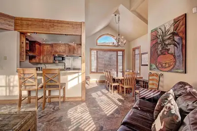 a kitchen and living room with a couch and a table at 18 Autumn Brook Condo in Keystone