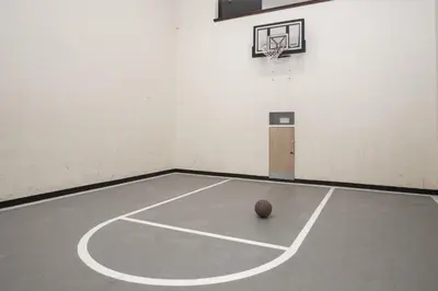 an empty basketball court with a ball on the floor at A11 Snowblaze Athletic Club Condo in Winter Park