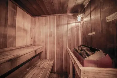 an empty wooden sauna with a box of logs at A11 Snowblaze Athletic Club Condo in Winter Park