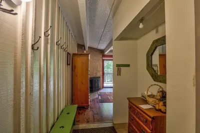 a hallway with a sink and a mirror in a room at Ten Mile Island 119C Condo in Frisco