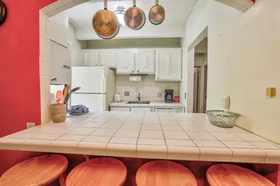 a kitchen with a counter top and a red wall at Ten Mile Island 119C Condo in Frisco
