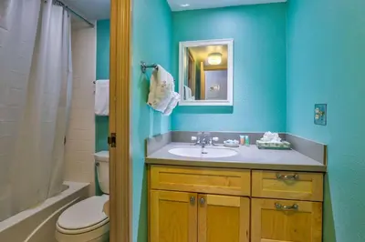 a bathroom with a sink and a toilet and a mirror at Ten Mile Island 119C Condo in Frisco