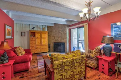 a living room with red walls and yellow furniture at Ten Mile Island 119C Condo in Frisco