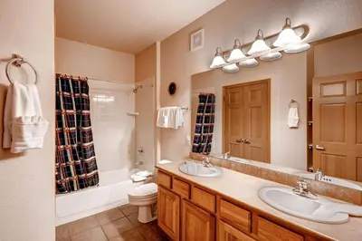 a bathroom with two sinks and a tub and a toilet at Tarn Landing C-5 Condo in Frisco